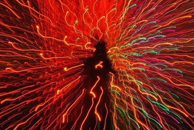 Low angle view of firework display at night