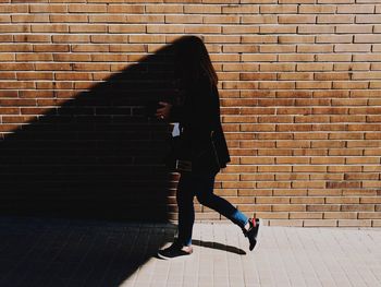 Woman standing on wall