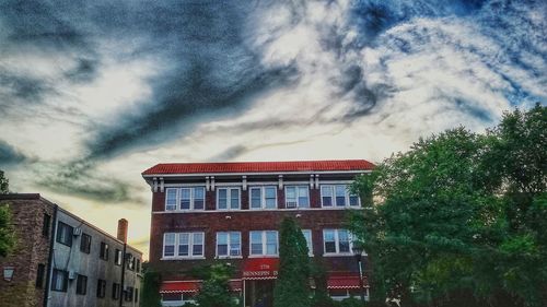 Low angle view of building against cloudy sky