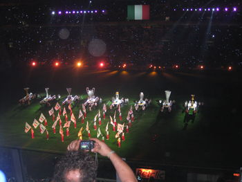 Group of people on illuminated stage at night