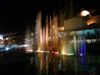 Illuminated fountain at night