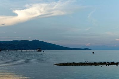 Scenic view of sea against cloudy sky