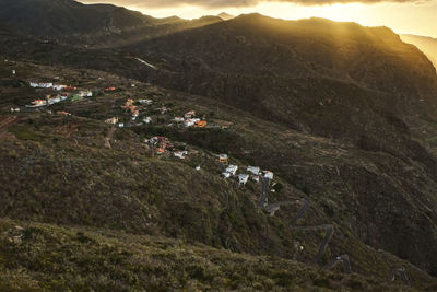 High angle view of land and mountains against sky