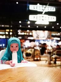 Portrait of cute girl drinking milk at restaurant