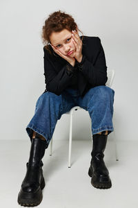 Portrait of young woman sitting on chair