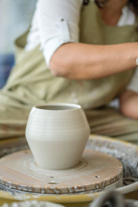 Woman making pottery on the wheel