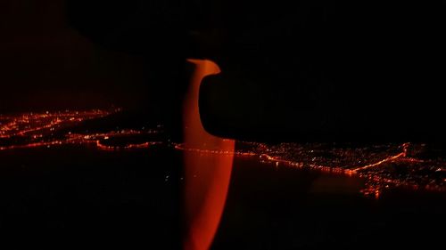 Close-up of illuminated fire against sky at night