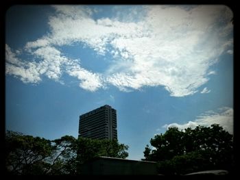 Low angle view of building against cloudy sky
