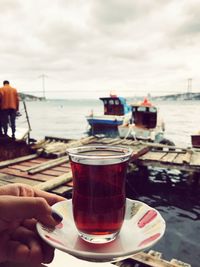 Cropped hand of woman holding turkish tea in glass