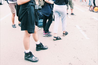 Low section of people on road in city