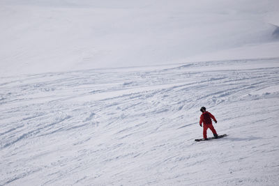 Full length of man skiing on snow covered landscape