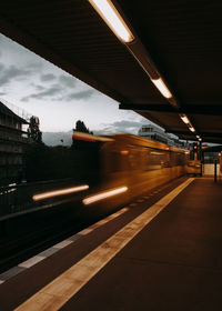 Train at railroad station platform against sky