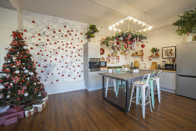 Interior of a cozy modern spacious kitchen for a large family, decorated for new year celebration