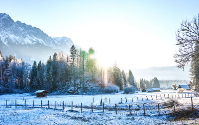 Scenic view of snow covered field against sky