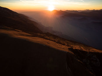 Scenic view of mountains against sky during sunset