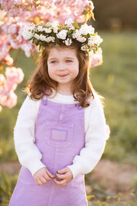 Cute girl wearing wreath looking away