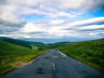 Empty road leading towards mountains