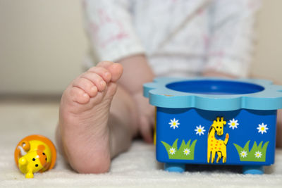 Close-up of baby playing with toy on table