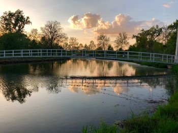 Bridge over river against sky during sunset