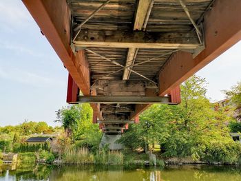 Low angle view of bridge over lake against sky