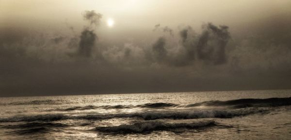 Scenic view of sea against cloudy sky