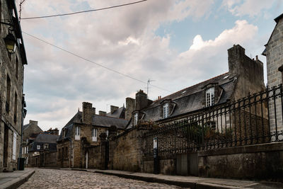 Old cobblestoned street with stone medieval houses in the town centre of dinan, french brittany