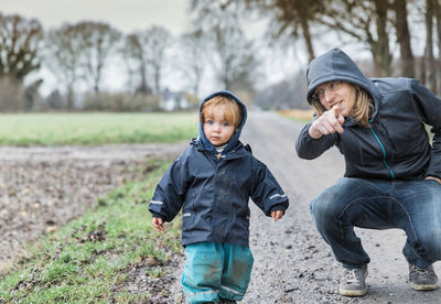 Man pointing with daughter on road