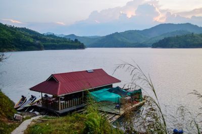 Scenic view of lake and mountains against sky