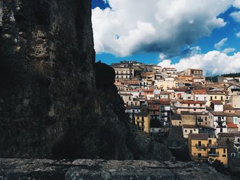 Buildings against cloudy sky