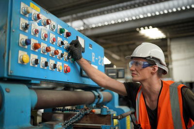 Portrait of male worker standing in the heavy industry manufacturing factory.