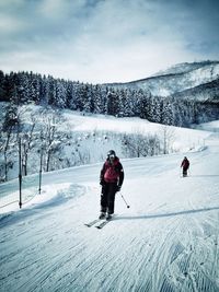 People walking on snow covered field