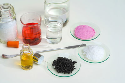 High angle view of drinks on table against white background