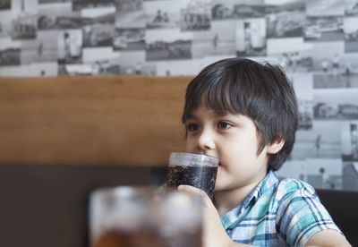 Portrait of boy drinking glass