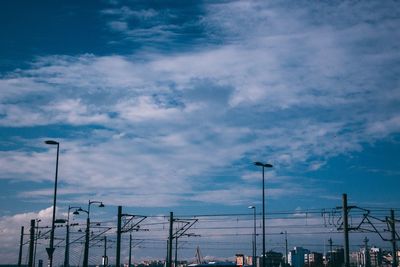 Low angle view of street light against cloudy sky