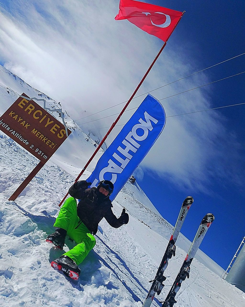 TILT IMAGE OF PEOPLE SKIING ON SNOWCAPPED MOUNTAIN