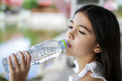 Close-up of girl drinking water