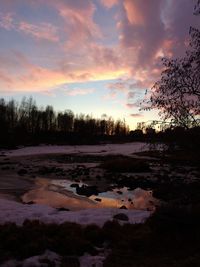 Scenic view of land against sky during sunset