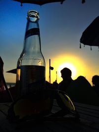 Silhouette of woman against sky at sunset