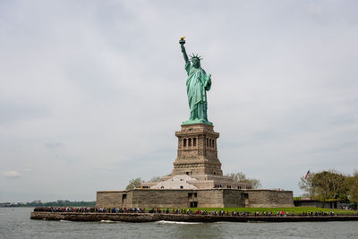 Statue of liberty against cloudy sky