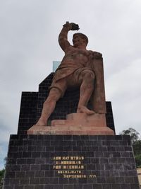 Low angle view of statue against sky