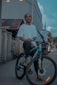 Low section of man riding bicycle on street