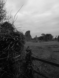 Hay bales on field against sky