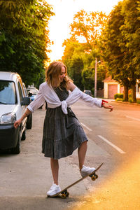 Rear view of women walking on road in city