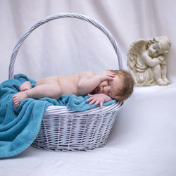 Cute baby sleeping in basket