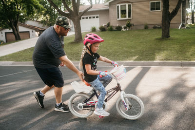 Portrait of boy riding bicycle on street