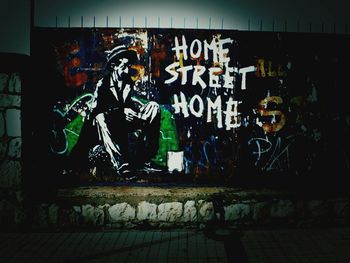 Graffiti on wall in city at night