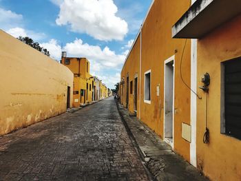 Alley amidst buildings against sky