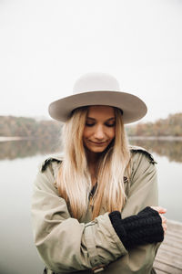 Portrait of woman wearing hat standing in winter