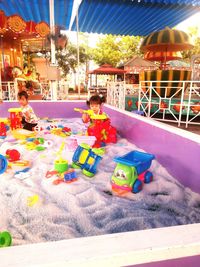 People sitting on amusement park ride at beach