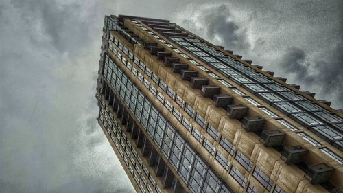 Low angle view of built structure against cloudy sky